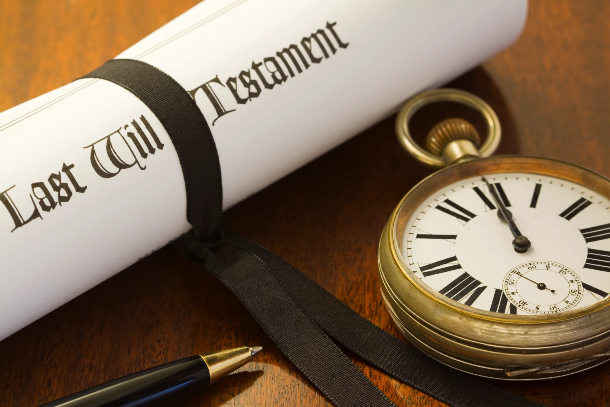Last will, pocket watch, and pen.