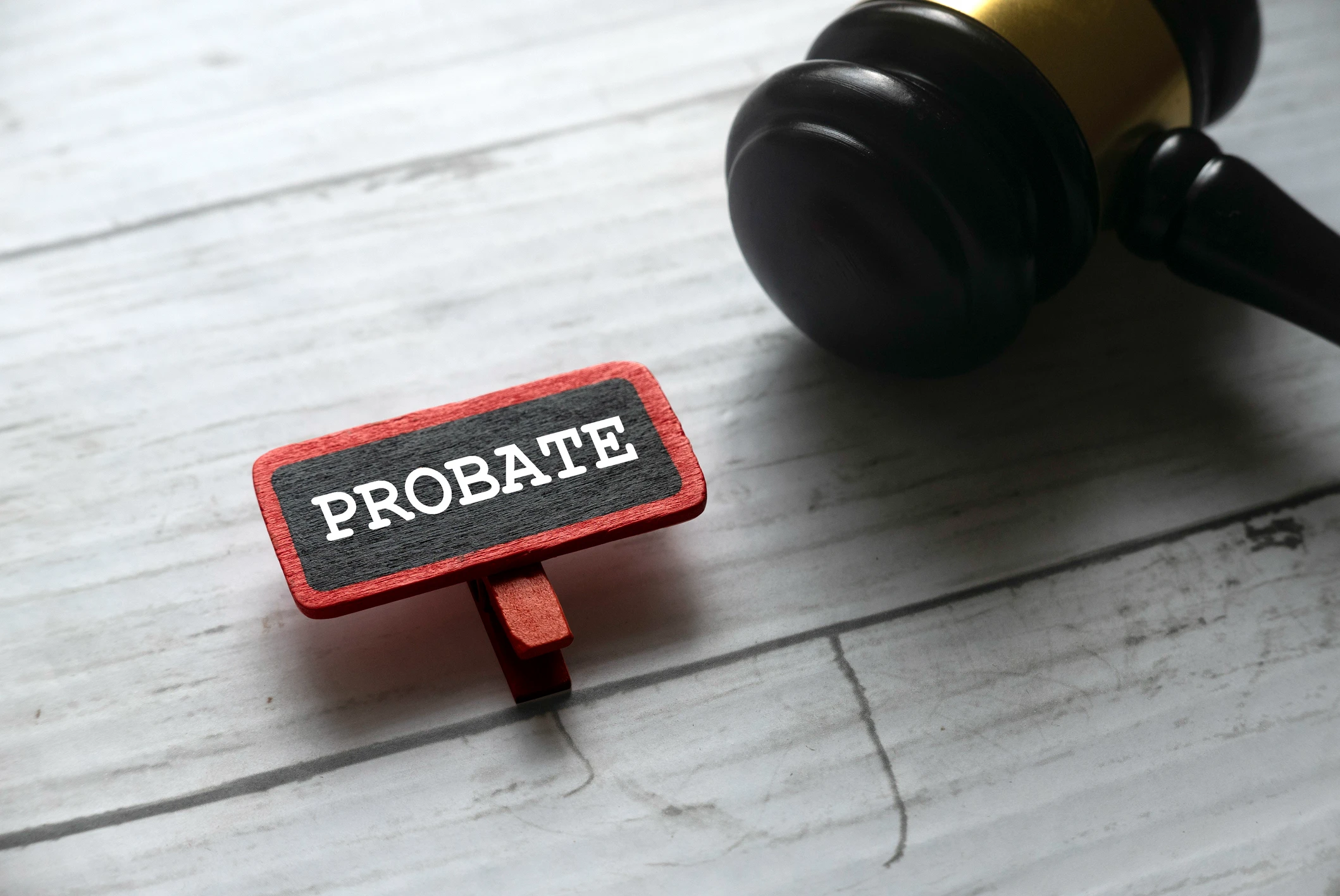 Gavel next to "Probate" sign on table.