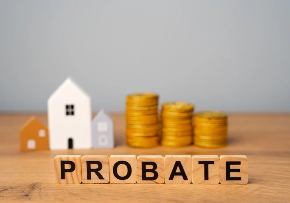 Probate concept with houses and coin stacks.